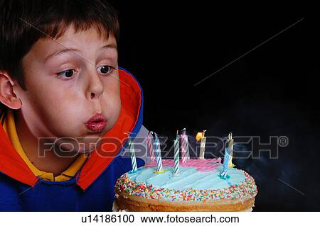 Blowing out the birthday candles View Large Photo Image Stock Image - Blowing out the birthday candles. Fotosearch