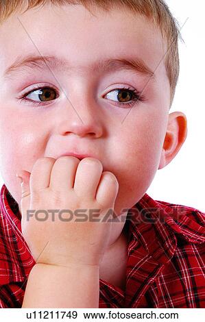 Boy biting his nails View Large Photo Image Stock Photo - Boy biting his nails. Fotosearch