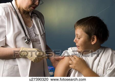 Stock Image - Boy getting a vaccine. Fotosearch