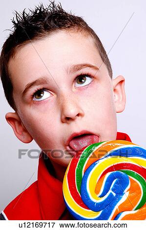 Stock Photo - Boy licking a lolly pop. Fotosearch