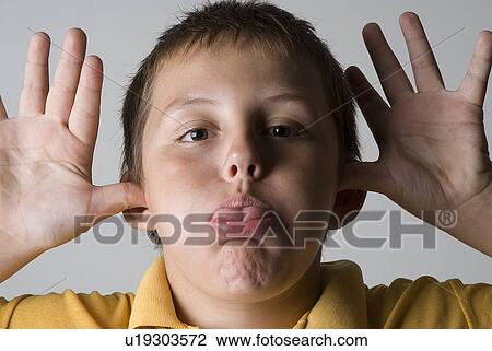 Stock Image - Boy making funny face. Fotosearch