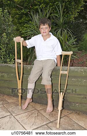 Stock Image - Boy on crutches. Fotosearch