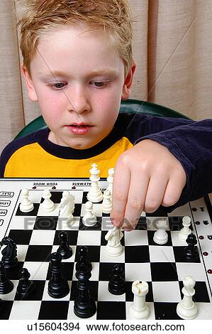Picture - Boy playing chess. Fotosearch