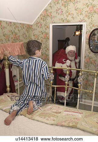 Stock Photo - Boy seeing Santa. Fotosearch
