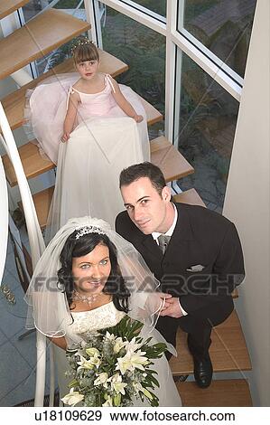 Stock Photo - Bride, Groom, and flower girl. Fotosearch