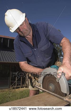 Builder with a circular saw View Large Photo Image Stock Image - Builder with a circular saw. Fotosearch