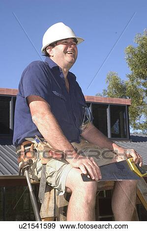 Builder with a saw View Large Photo Image Stock Photo - Builder with a saw. Fotosearch
