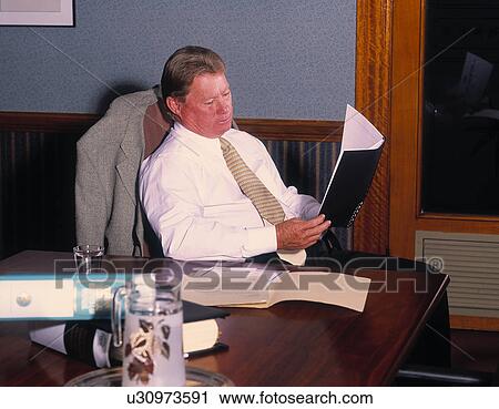 Business man reading a business plan View Large Photo Image Stock Image - Business man reading a business plan. Fotosearch