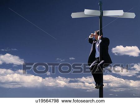 Businessman climbing a street sign in the sky View Large Photo Image Stock Photo - Businessman climbing a street sign in the sky. Fotosearch