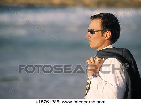 Businessman looking out on to the ocean View Large Photo Image Stock Photography - Businessman looking out on to the ocean. Fotosearch