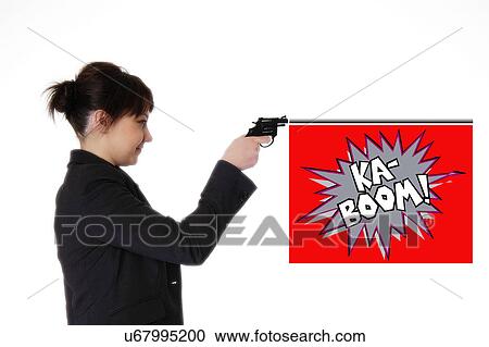 Stock Image - Businesswoman shooting a toy gun. Fotosearch