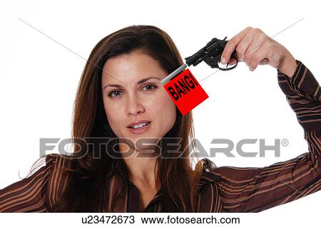 Stock Image - Businesswoman shooting a toy guy. Fotosearch