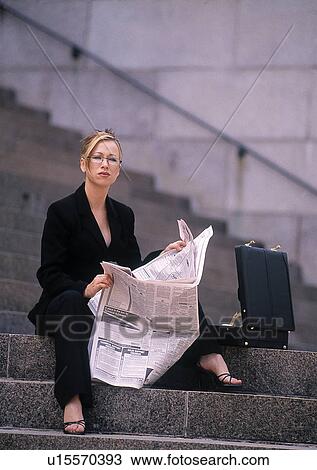 Businesswoman sitting on stairs reading the paper View Large Photo Image Stock Image - Businesswoman sitting on stairs reading the paper. Fotosearch