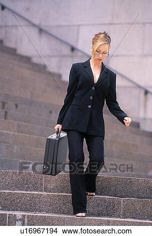 Businesswoman walking downstairs View Large Photo Image Picture - Businesswoman walking downstairs. Fotosearch