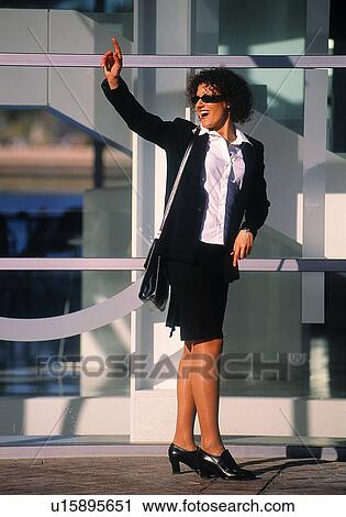 Businesswoman waving outside View Large Photo Image Stock Image - Businesswoman waving outside. Fotosearch