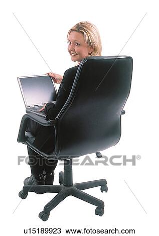 Stock Image - Businesswoman working on a laptop. Fotosearch
