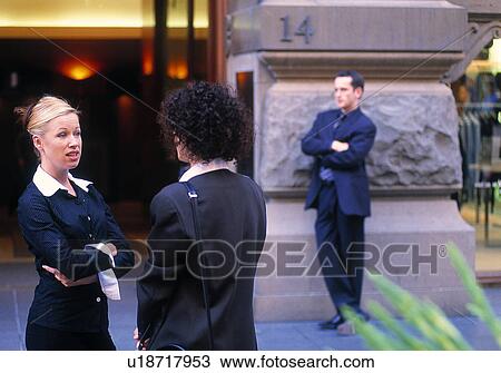 Stock Image - Businesswomen talking outside. Fotosearch
