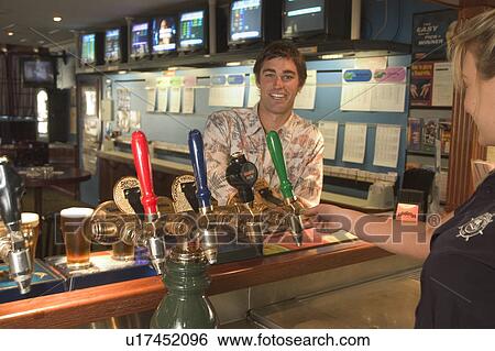 Stock Photograph - Buying a beer at a bar. Fotosearch