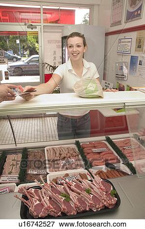Stock Photo - Buying from the butcher. Fotosearch
