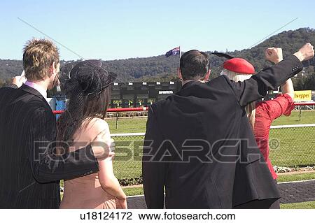 Stock Image - Cheering at the horse track. Fotosearch