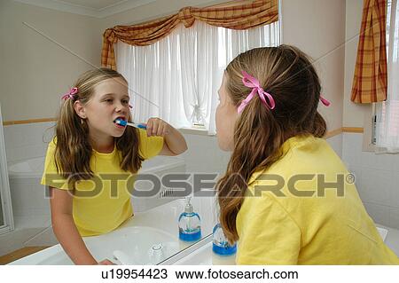 Child brushing her teeth in the bathroom View Large Photo Image Stock Image - Child brushing her teeth in the bathroom. Fotosearch