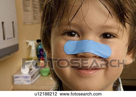 Child with band-aid on his nose View Large Photo Image Stock Image - Child with band-aid on his nose. Fotosearch