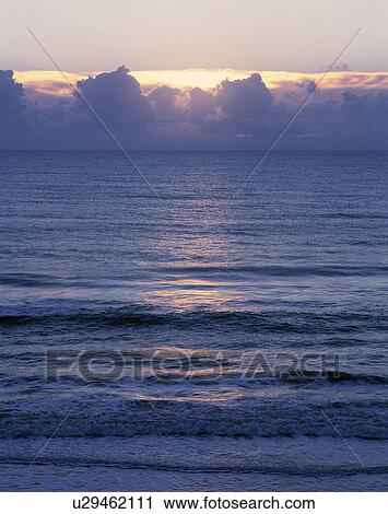 Stock Image - Clouds over water. Fotosearch