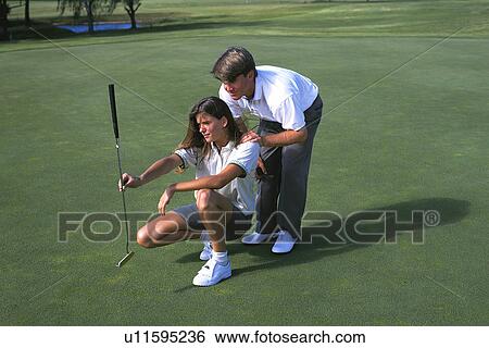 Stock Photograph - Coaching to putt. Fotosearch