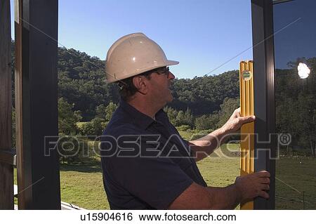 Construction worker setting a window View Large Photo Image Stock Photograph - Construction worker setting a window. Fotosearch