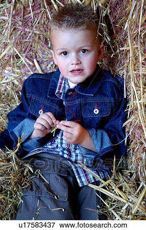 Country boy in the hay View Large Photo Image Stock Photo - Country boy in the hay. Fotosearch