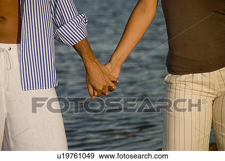 Stock Photo - Couple holding hands. Fotosearch
