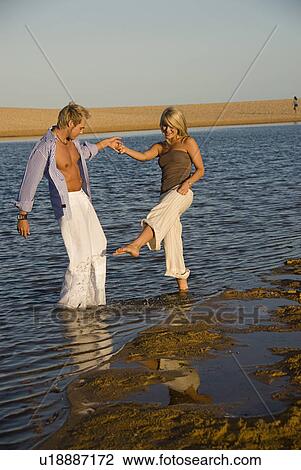 Stock Image - Couple in the water. Fotosearch