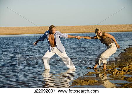 Stock Photo - Couple in the water. Fotosearch