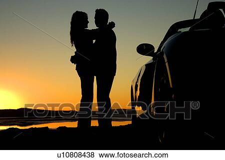 Couple on the beach at sunset View Large Photo Image Stock Photo - Couple on the beach at sunset. Fotosearch