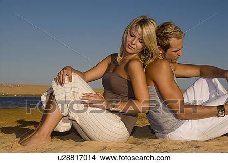 Couple sitting on the beach View Large Photo Image Picture - Couple sitting on the beach. Fotosearch