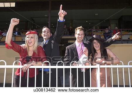 Stock Image - Couples at the horse races. Fotosearch