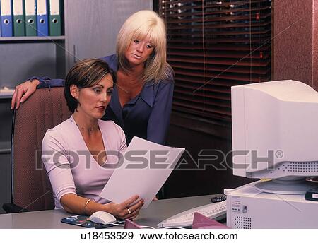 Stock Photo - Coworkers review report. Fotosearch