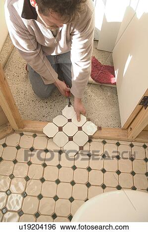 Stock Photograph - Cutting tile. Fotosearch