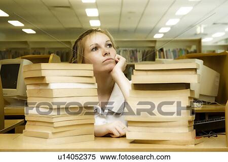 Stock Photography - Day dreaming in the library. Fotosearch