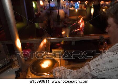Stock Image - DJ at nightclub. Fotosearch