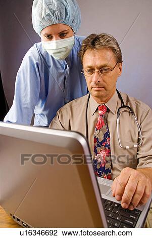 Doctor and nurse on the computer View Large Photo Image Stock Image - Doctor and nurse on the computer. Fotosearch