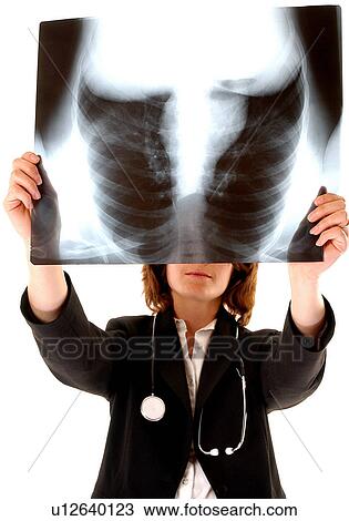Stock Image - Doctor examining x-rays. Fotosearch