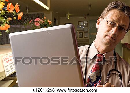 Stock Photo - Doctor in his office. Fotosearch
