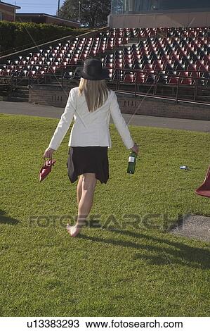 Stock Image - Drunk lady at the races. Fotosearch