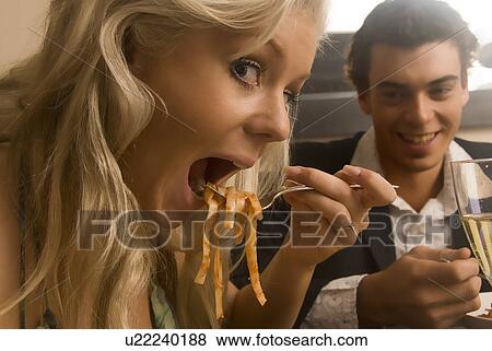 Stock Photo - Eating pasta on a date. Fotosearch
