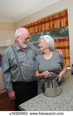 Elderly couple cooking dinner View Large Photo Image Stock Image - Elderly couple cooking dinner. Fotosearch