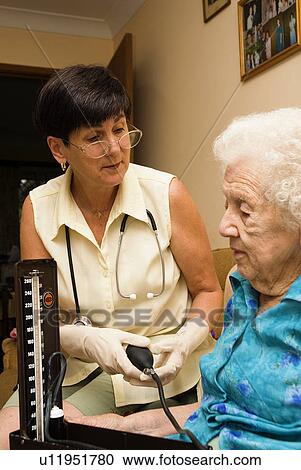 Elderly getting her blood pressure taken View Large Photo Image Stock Image - Elderly getting her blood pressure taken. Fotosearch