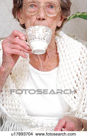 Picture - Elderly woman drinking tea. Fotosearch