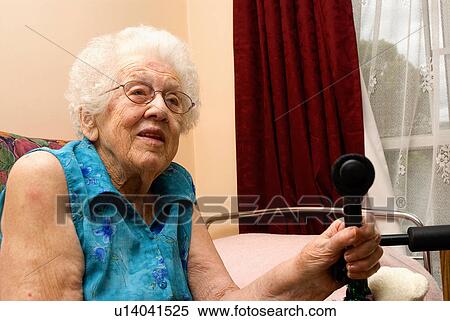 Stock Photography - Elderly woman sitting in bed. Fotosearch