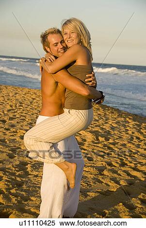 Embracing at the beach View Large Photo Image Stock Photography - Embracing at the beach. Fotosearch